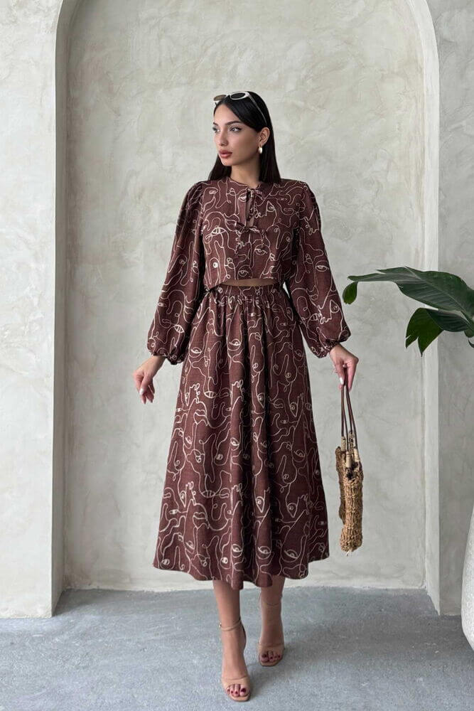 Model showcasing a Boho printed two-piece linen set, featuring a chic blouse and matching skirt in earthy tones.