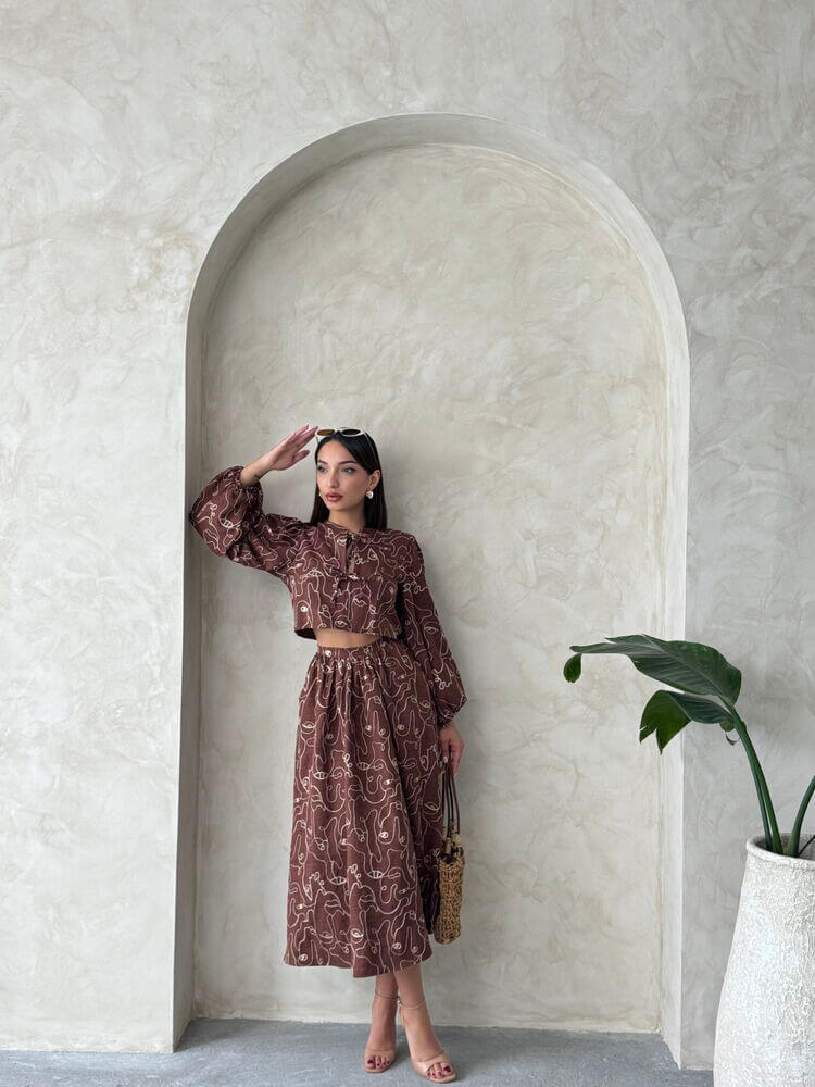 Model showcasing a Boho print two-piece linen set, featuring a cropped blouse and patterned skirt against a minimalist backdrop.