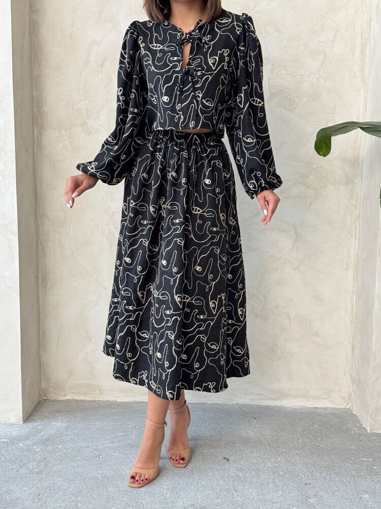 Model showcasing a Boho print linen two-piece set, featuring a blouse and skirt, perfect for casual or workwear.
