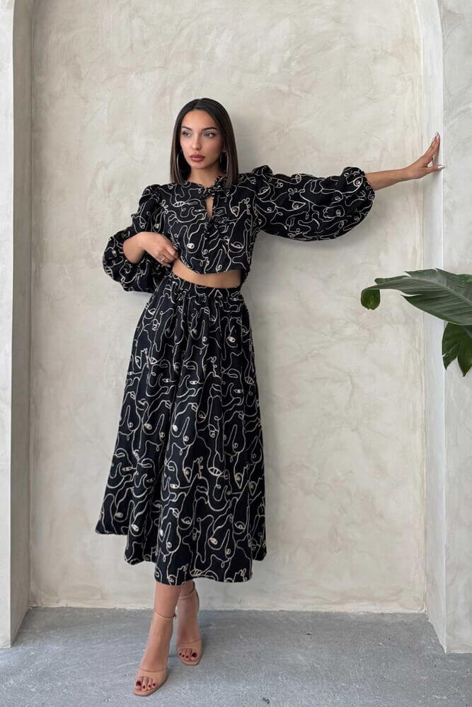 Model wearing a stylish Boho print linen two-piece set featuring a chic blouse and skirt.