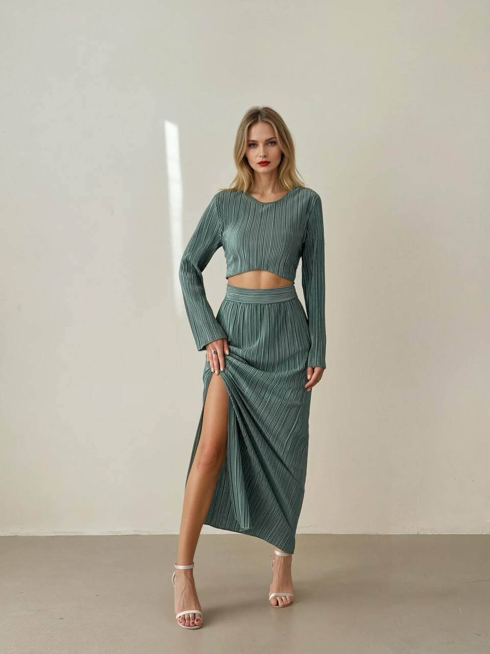 Chic women's long-sleeve crop top and high-slit maxi skirt set in pleated lightweight fabric for elegant comfort.