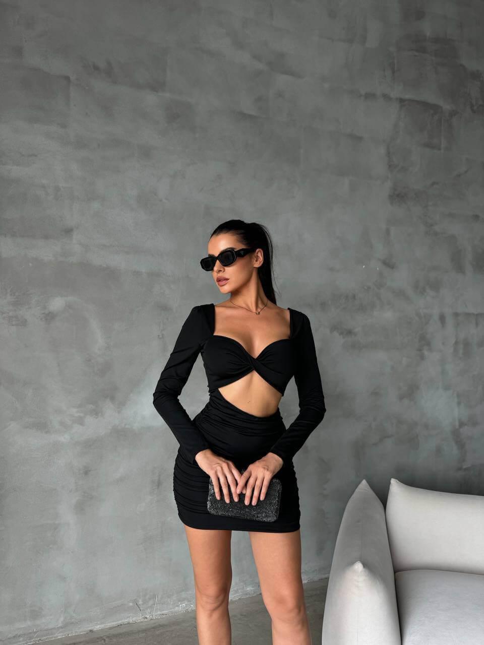 Women's Short Black Skinny Dress with a Bra-Style Top, Open Back, Stretchy Fabric, and Length Below the Hips