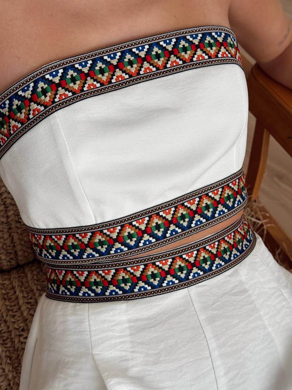 Detail image of the white bohemian two-piece set, showing the material and the sewing details.