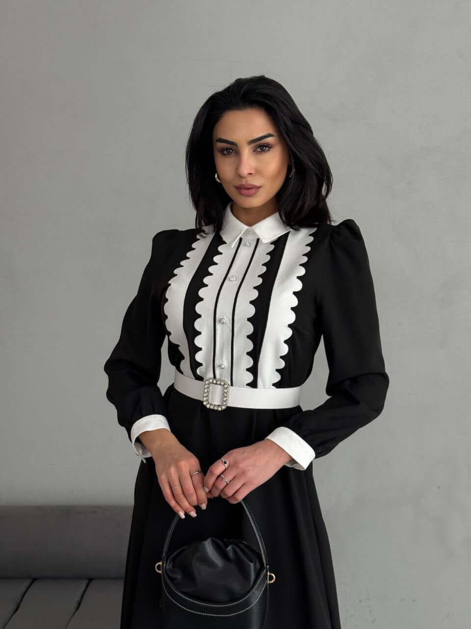 A close-up of the black and white maxi dress, focusing on the collar, buttons, and waist belt details.
