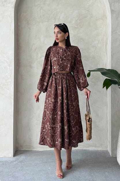 Model showcasing a Boho printed two-piece linen set, featuring a chic blouse and matching skirt in earthy tones.