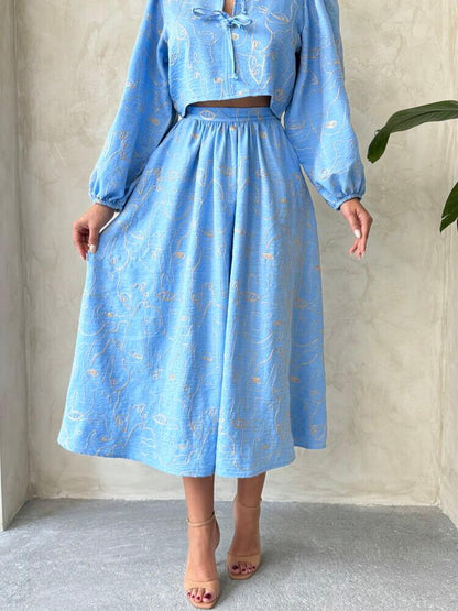 Boho print linen two-piece set featuring a light blue blouse and matching skirt for a stylish summer look.