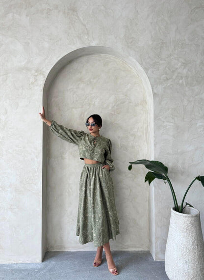 Model in a Boho print linen two-piece set, featuring a chic blouse and skirt, styled against a minimalist backdrop.