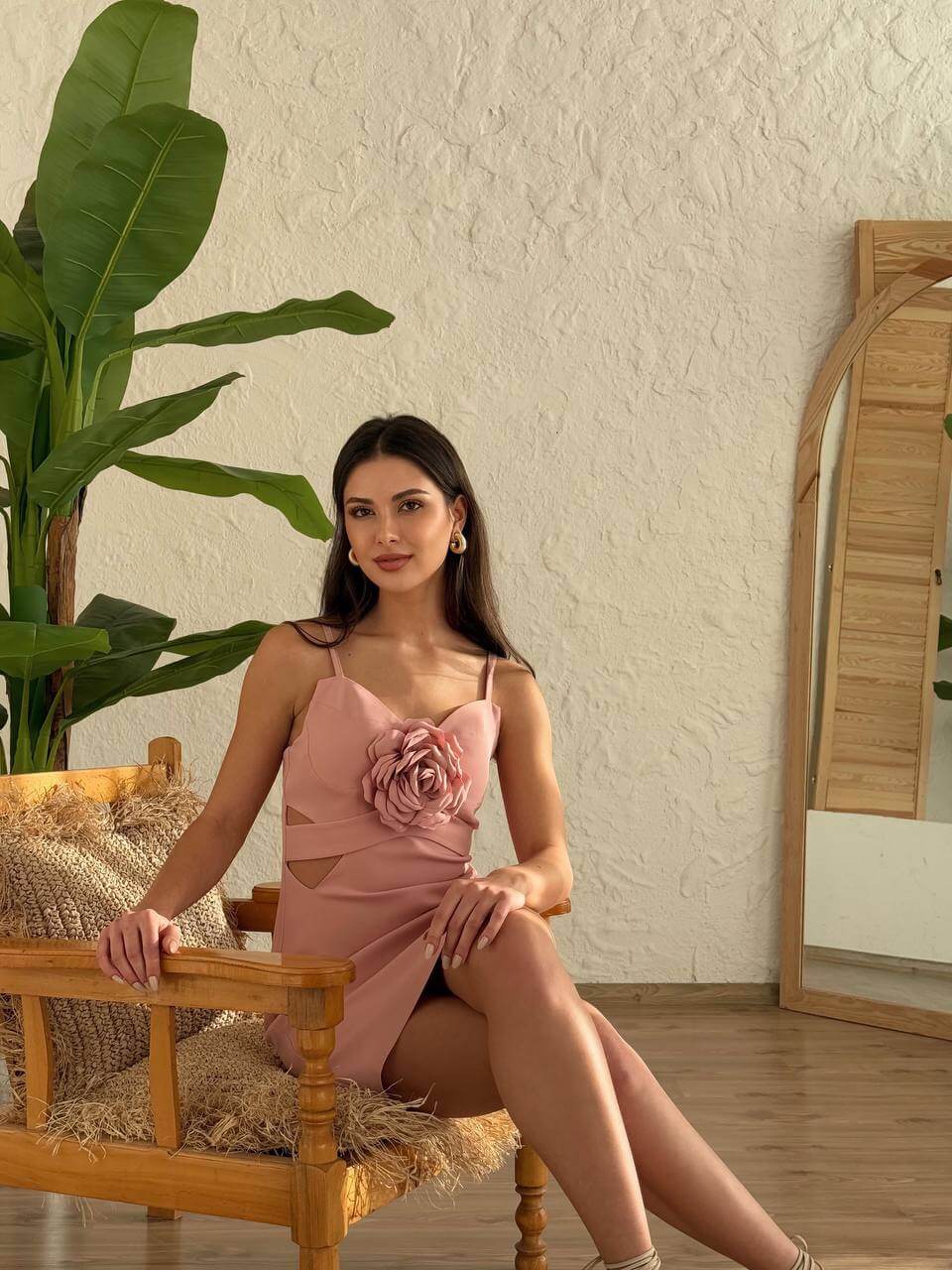 Woman modeling a pink floral mini dress with a sweetheart neckline, posing front-facing.