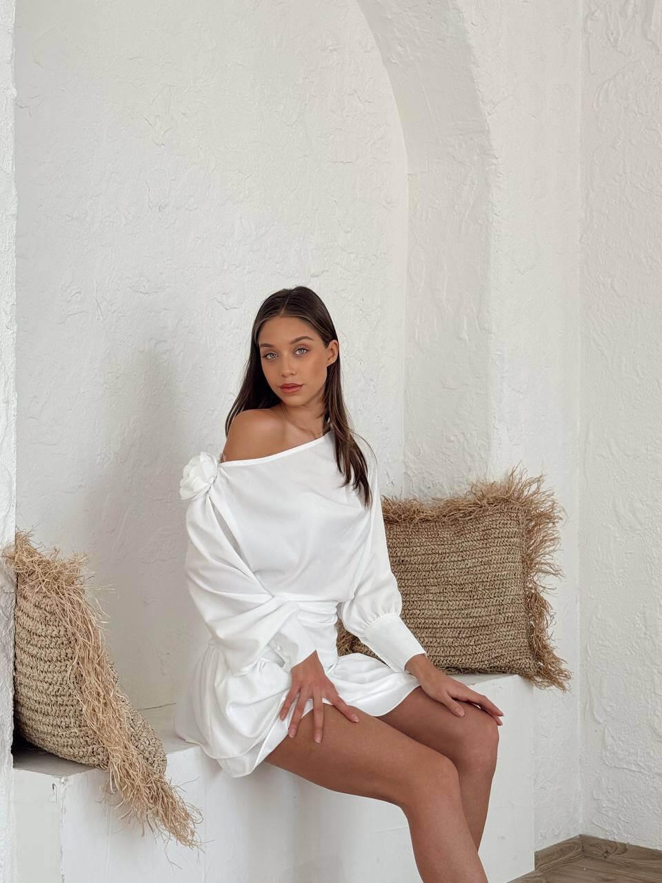 White long-sleeve short dress with a boat neckline.