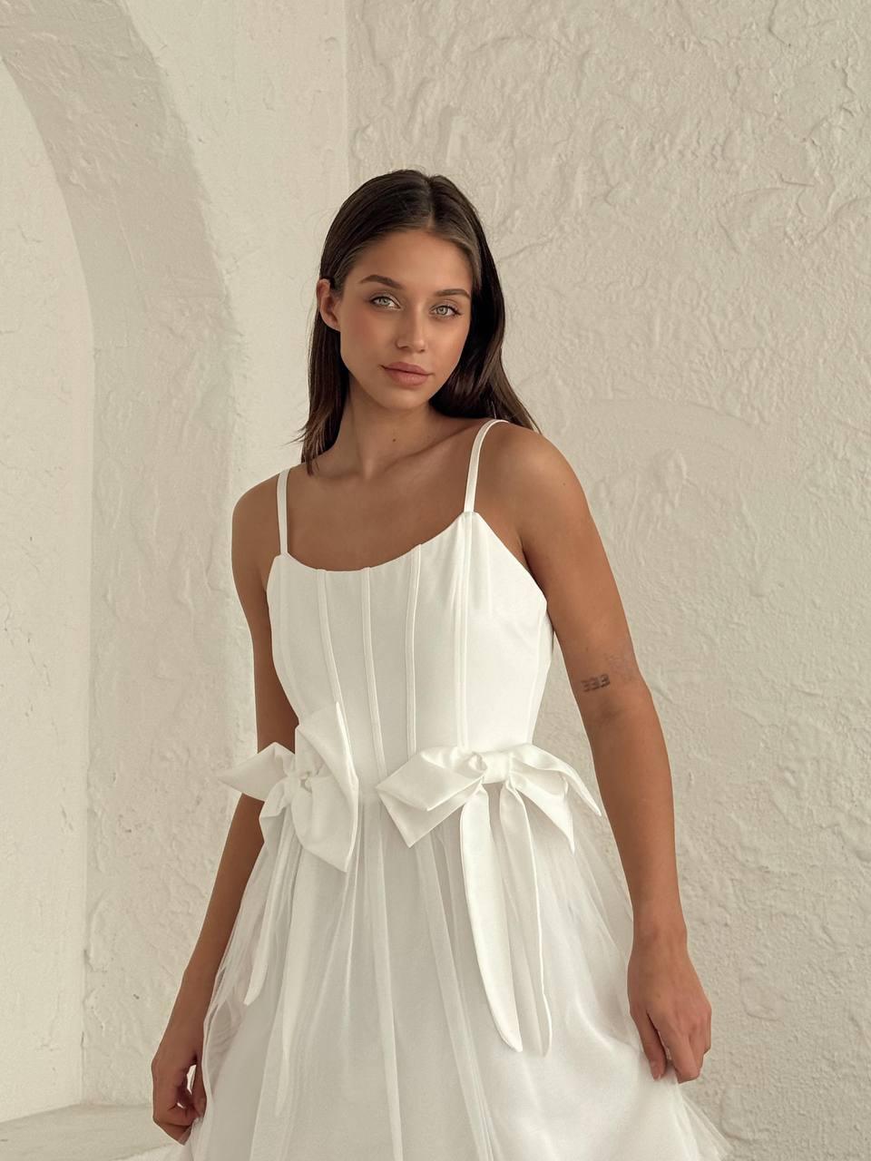 Women's short white sleeveless dress above the knee