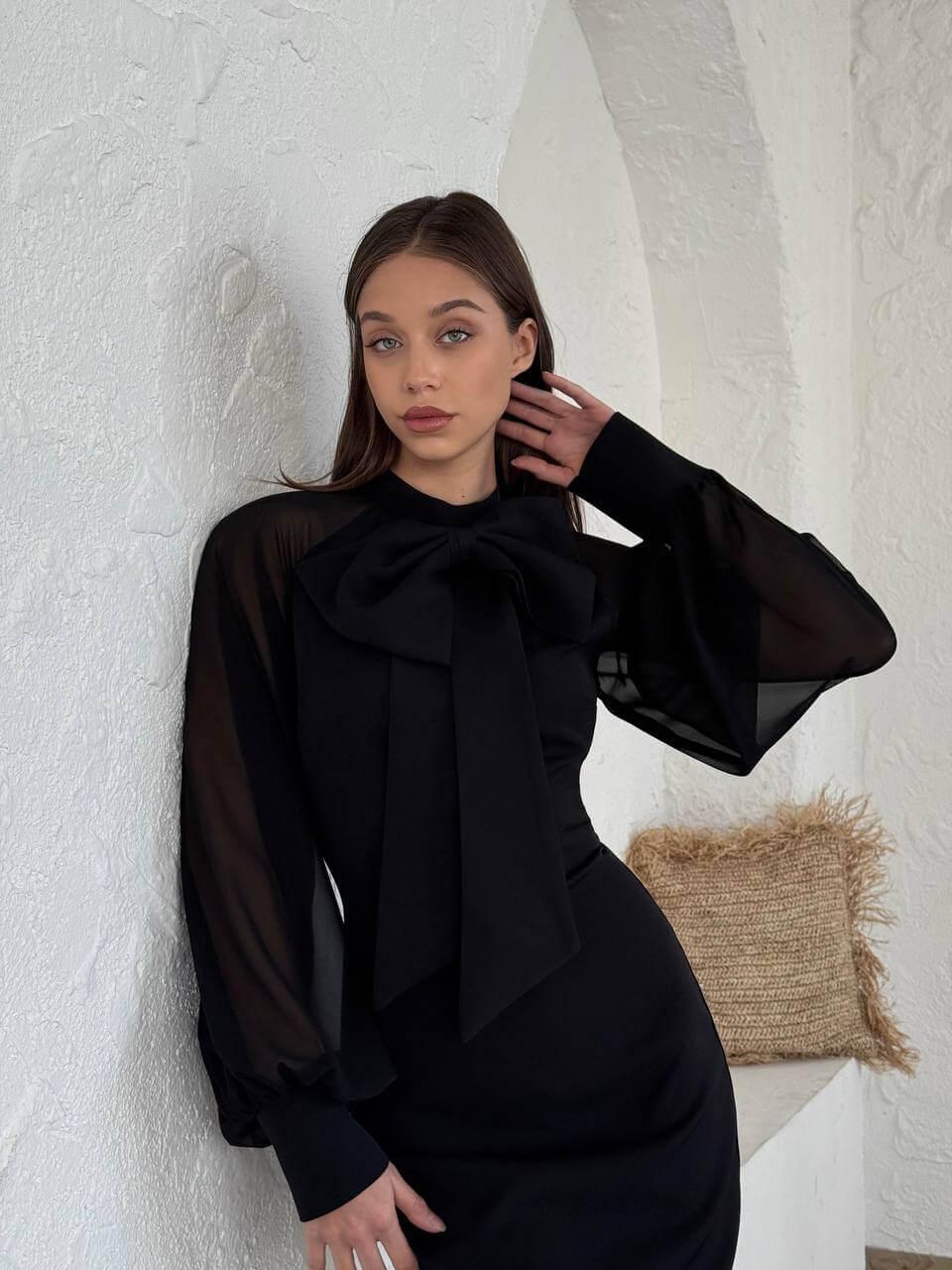Black long-sleeve short dress with a bow-tie collar.