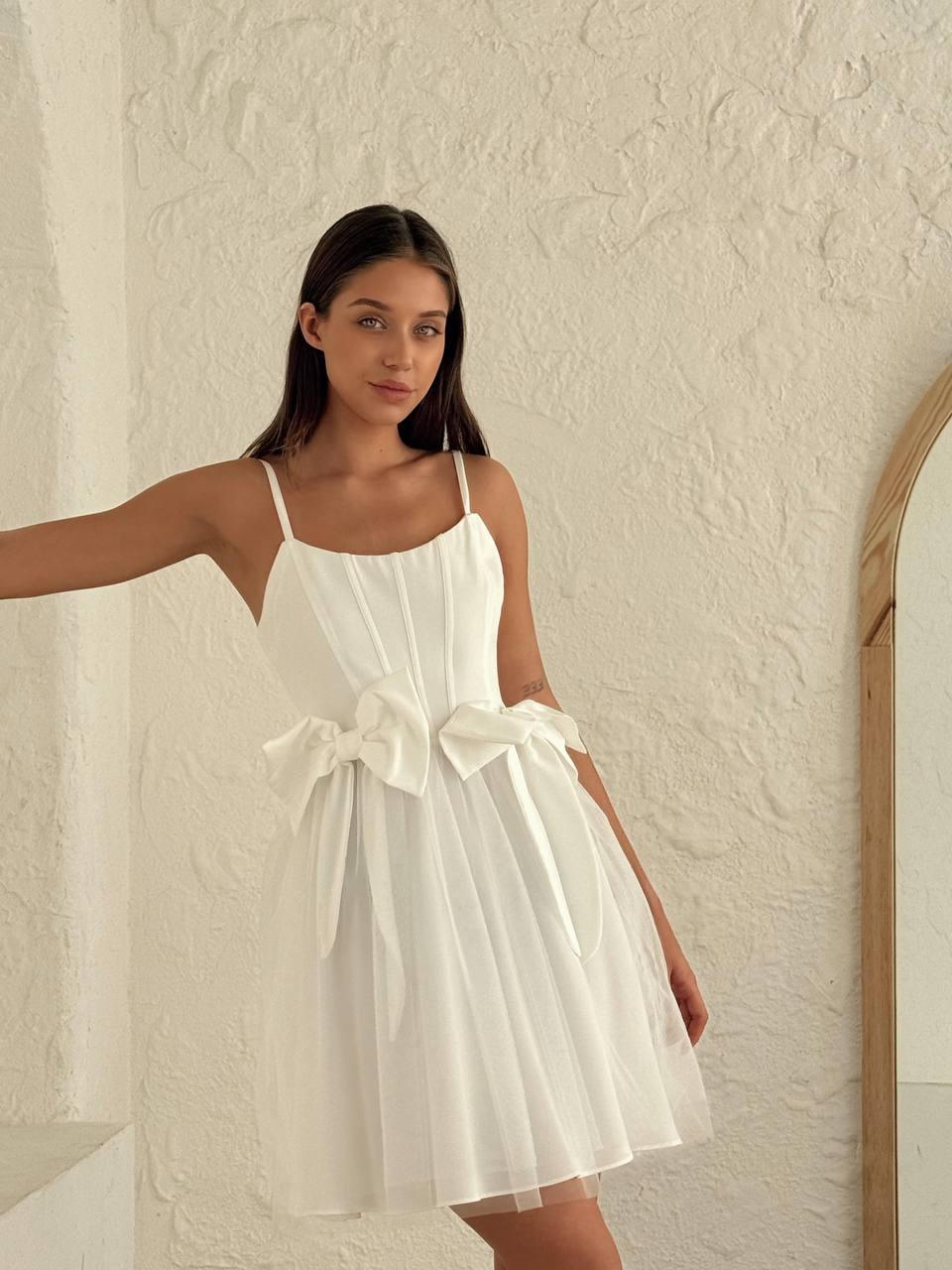 Women's short white sleeveless dress above the knee