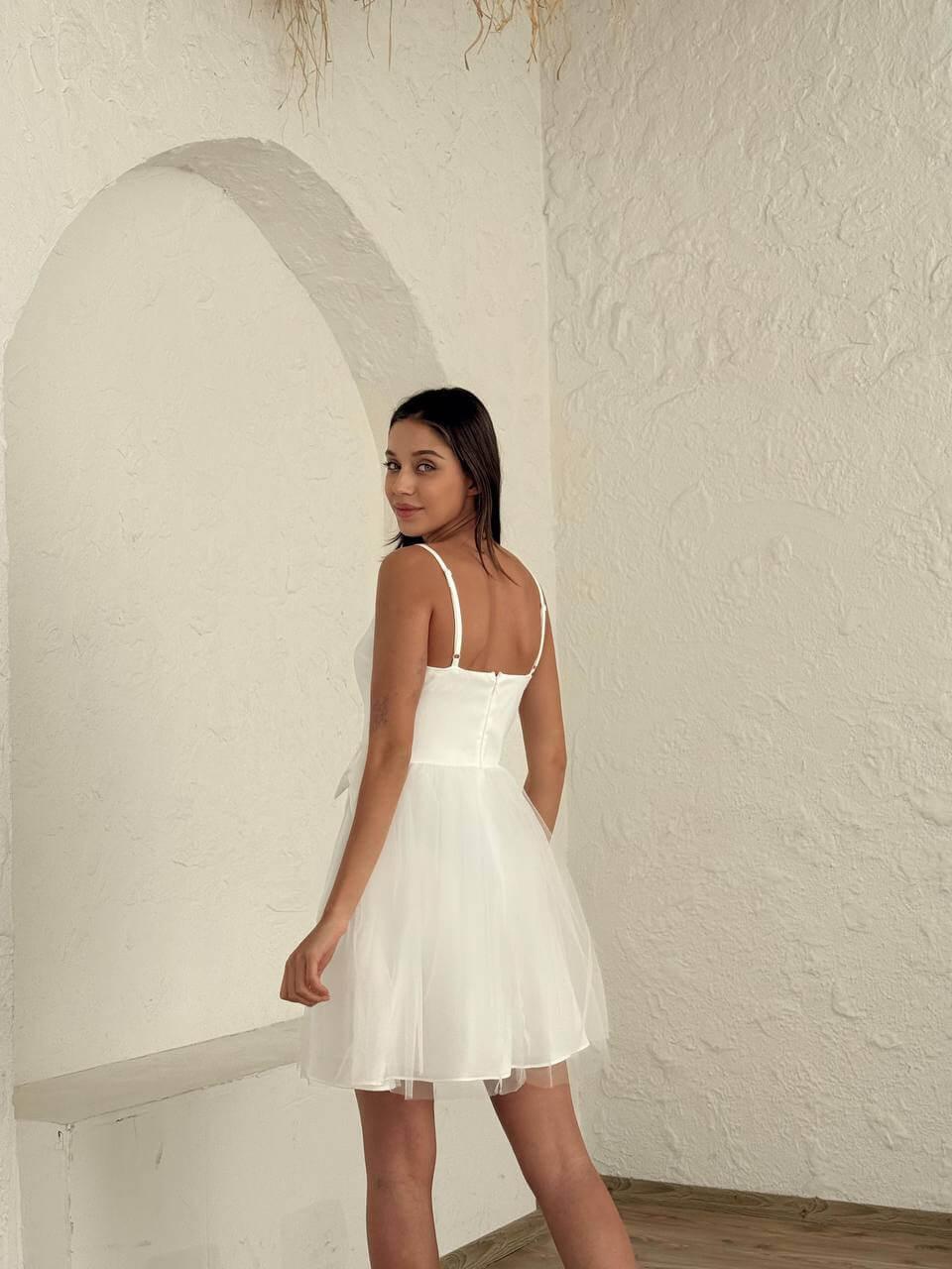 Women's short white sleeveless dress above the knee