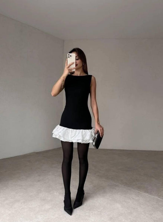 black-white sleeveless short dress with pin-pleated skirt.