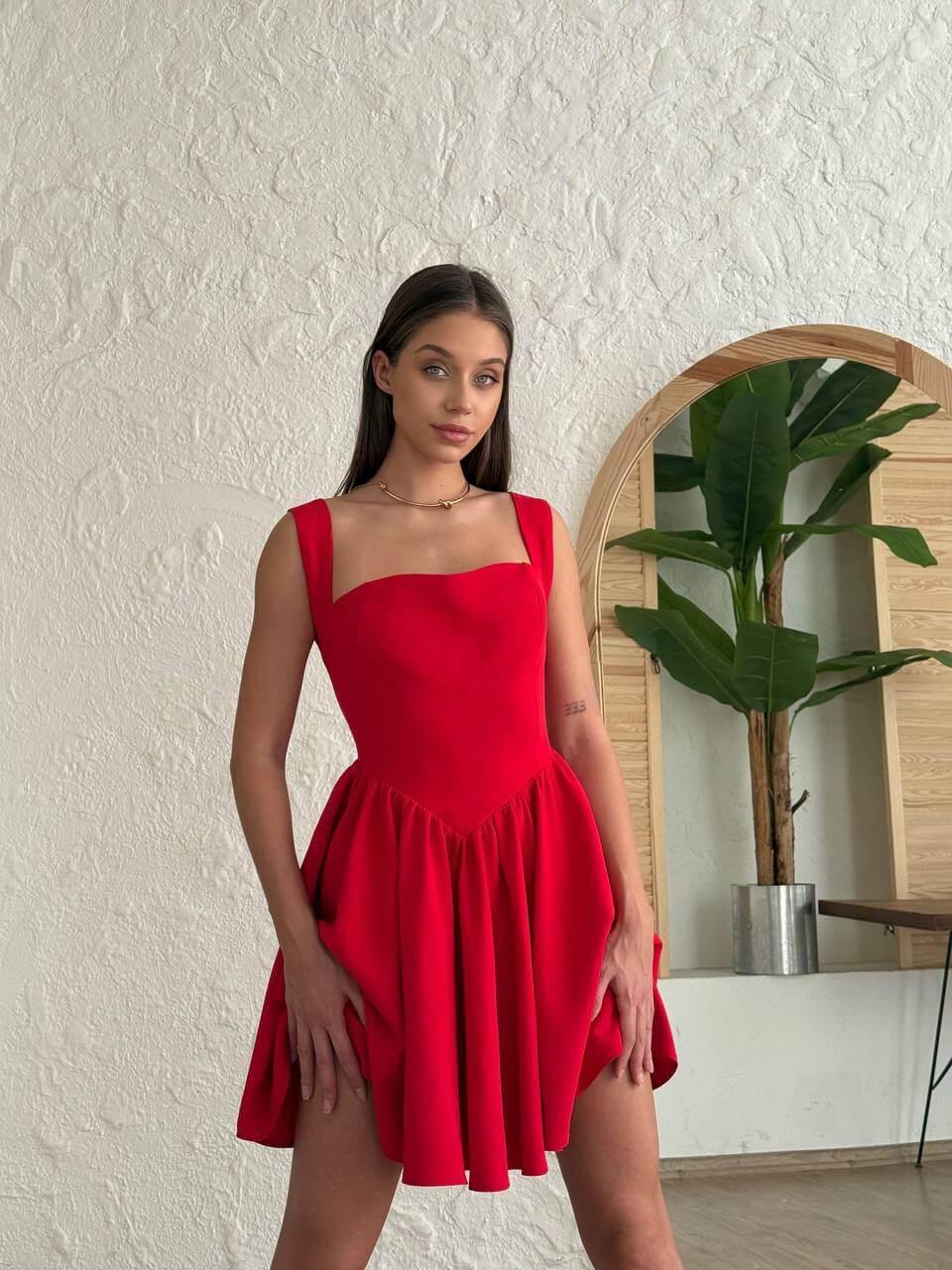 Short red-colored dress with a halter neckline, open back, and flared skirt.
